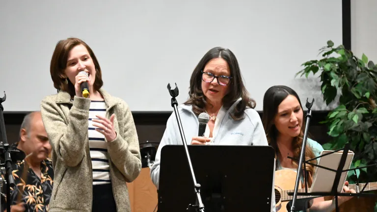 a group of three women singing
