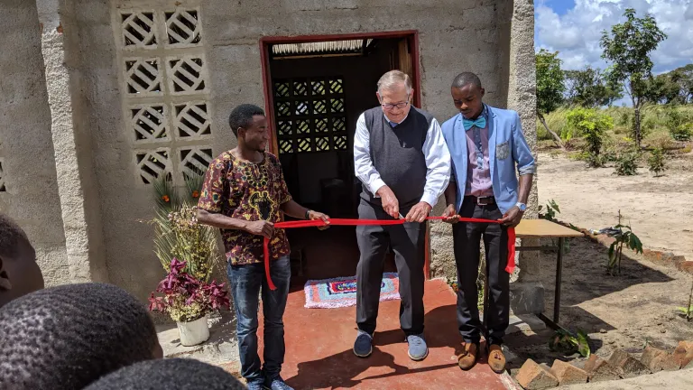 Mr. Kubik cuts the ribbon at the ceremony.