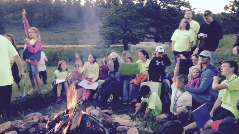 Campers and staff around the fire.