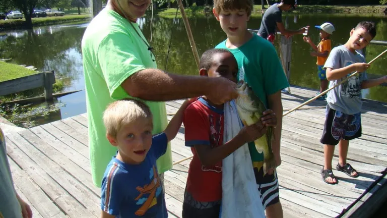 Campers fishing with staff.