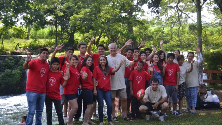 Campers pose and wave at the camera with Mr. Seiglie.