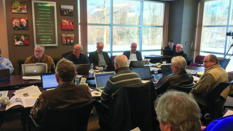 Members of the Council of Elders gather at the Home Office for their quarterly meeting.