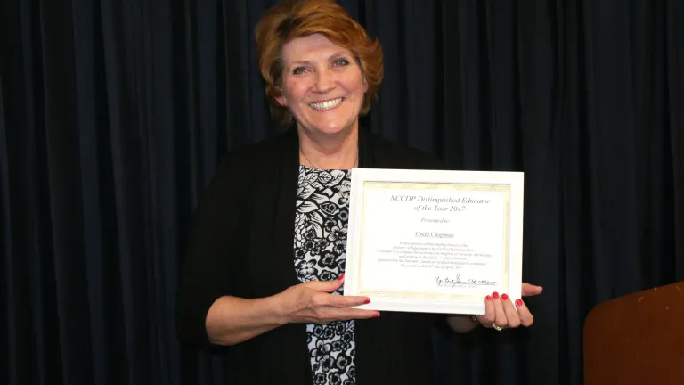Linda “Andi” Chapman holding her “Educator of the Year” award.