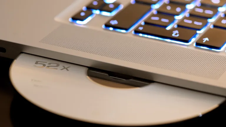 A laptop keyboard and CD