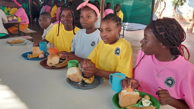 a group of children outdoors under a tent