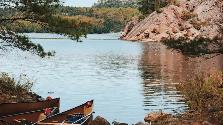 two canoes on the shore of a lake