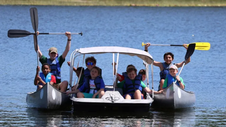 a group of campers in canoes on a lake