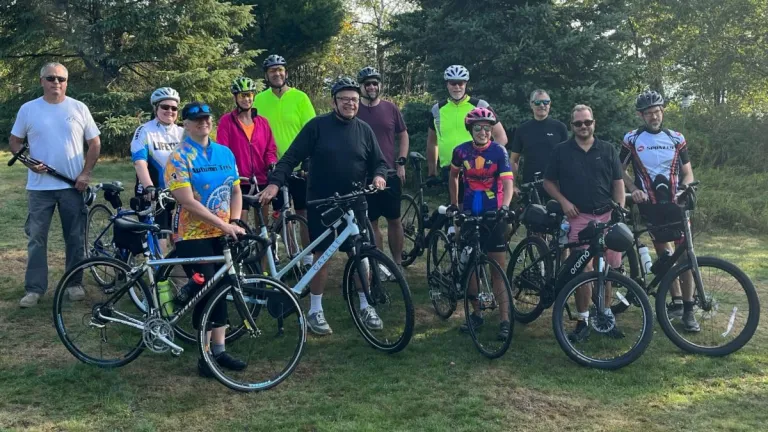 a group of people standing outdoors with their bicycles