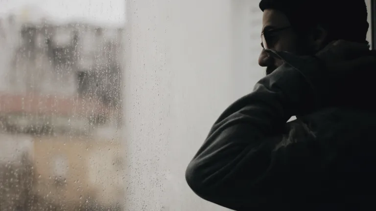 A man looking out a window.