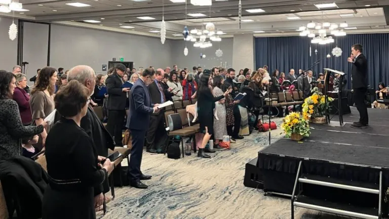 a group of brethren singing hymns in the meeting hall