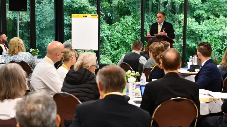 Darris McNeely gives a presentation to a seated group.