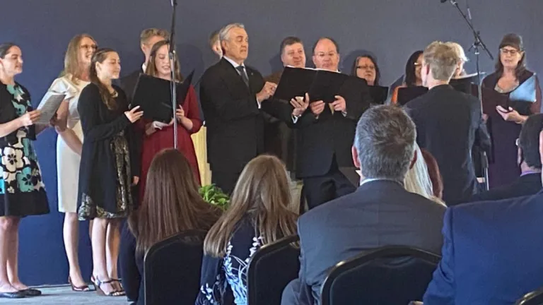 The choir sings in the first church service in the new Tulsa main meeting hall.