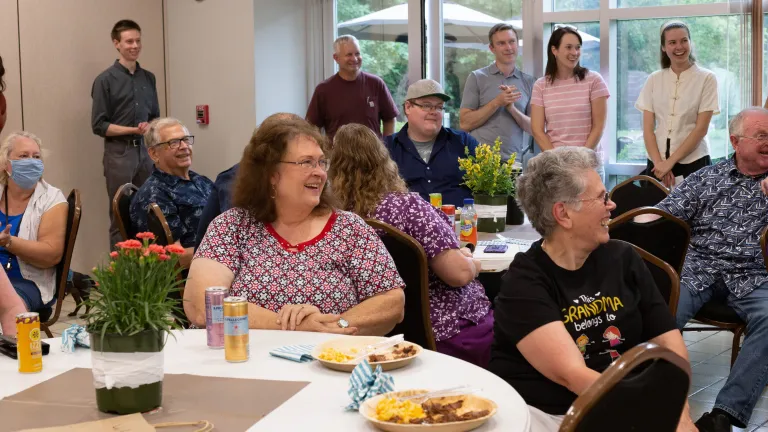 Employees and their families watch the raffle drawing after lunch.