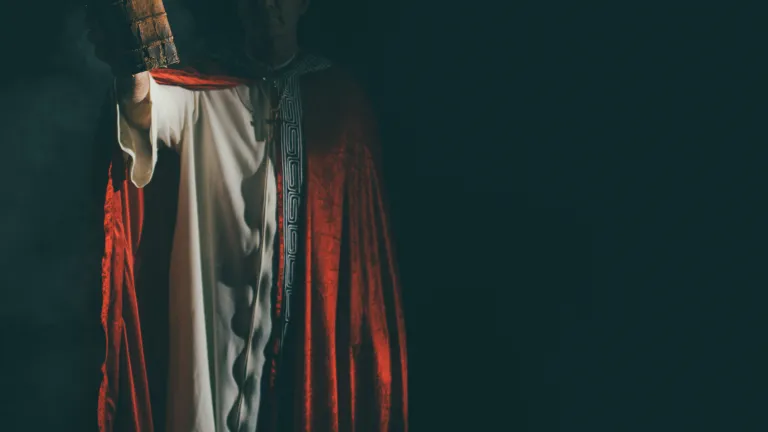 Image of antichrist-like figure holding a Bible.