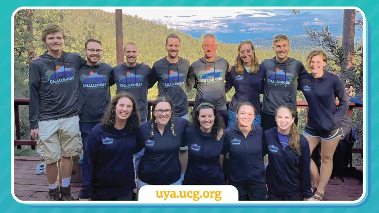 a group of young adults standing outdoors with matching shirts with a website link in the foreground, uya.ucg.org