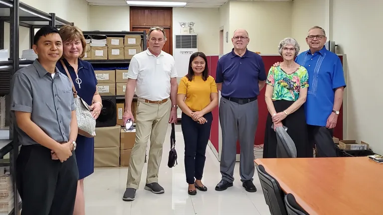 Inside the Philippines office: Richard Macaraeg, Debbie and Darris McNeely, Stella Cambare, David Dobson, Bev and Vic Kubik.