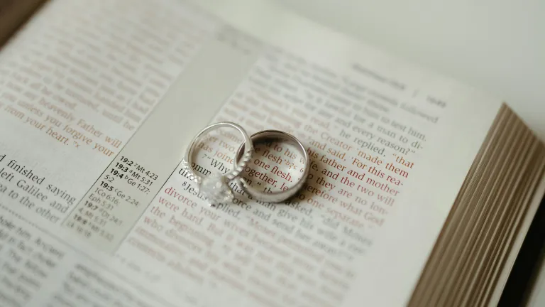 a set of wedding rings on a bible