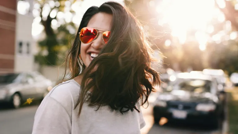 a smiling woman with sunglasses
