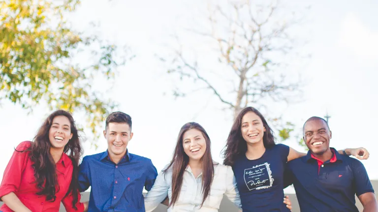 Group of people sitting on stone bench