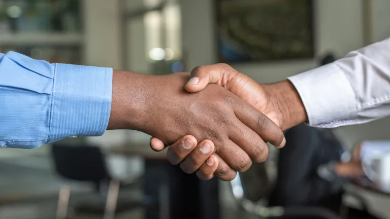 The home office recently hired four individuals. a handshake