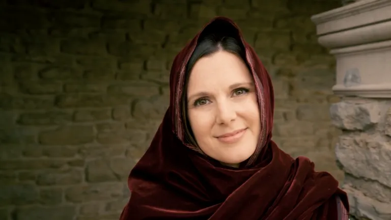 a smiling woman wearing Bible robes