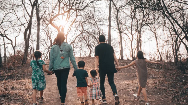 God is looking for people who will give themselves up so others can grow and succeed. a family holding hands as they walk outdoors