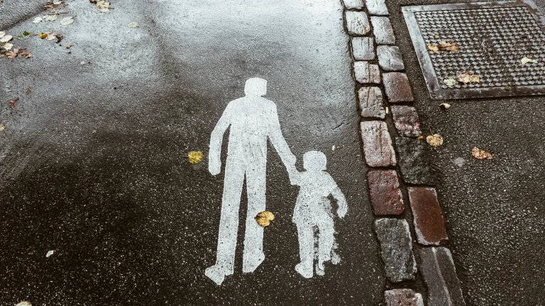 A street with a stencil of a father and child