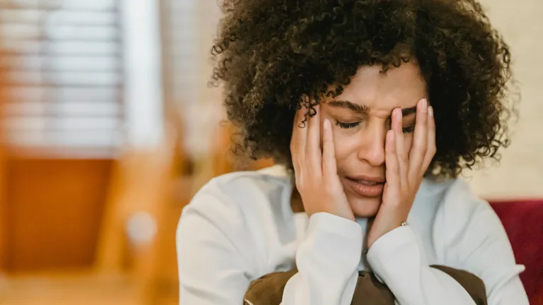 a woman with her head in her hands
