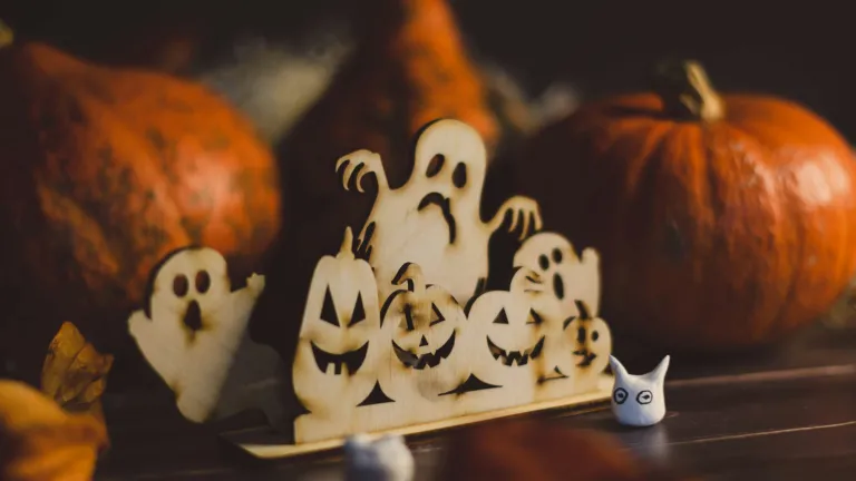 Wooden cutout on a table of jack-o'-lanterns and ghosts