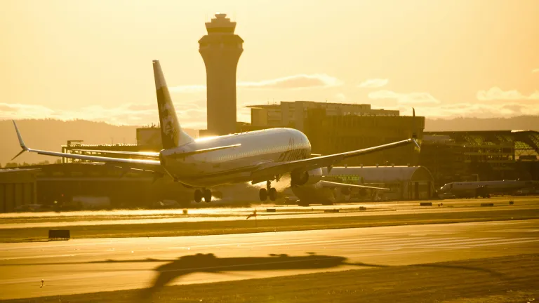 Plane landing with a shadow underneath it