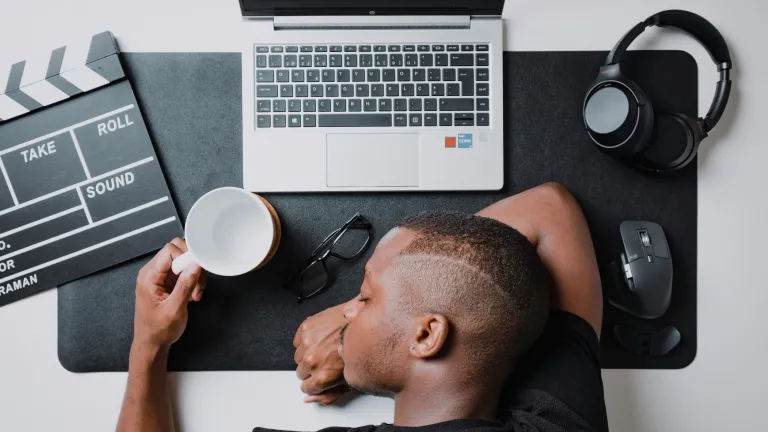 A man asleep on a desk