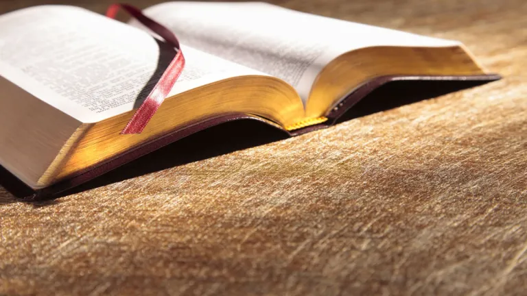 An open Bible on a table.