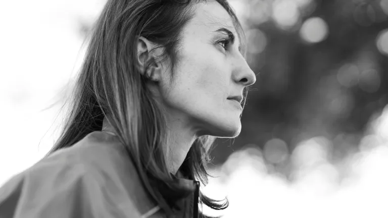 A woman looking ahead in deep thought.