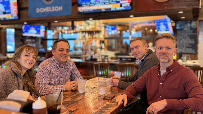 four people seated in a restaurant