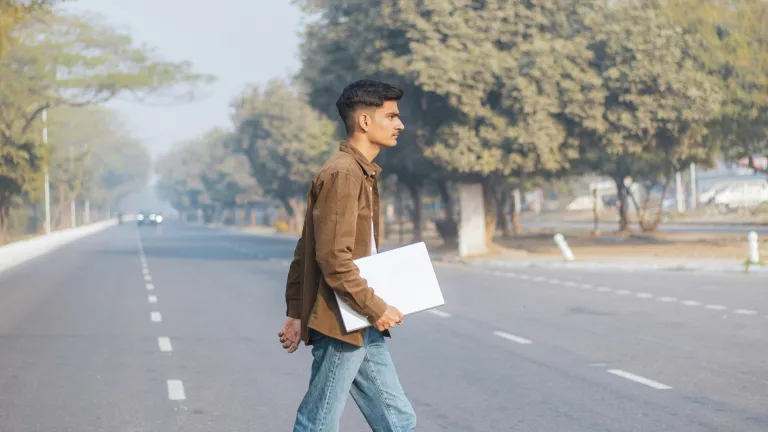 Young man crossing street