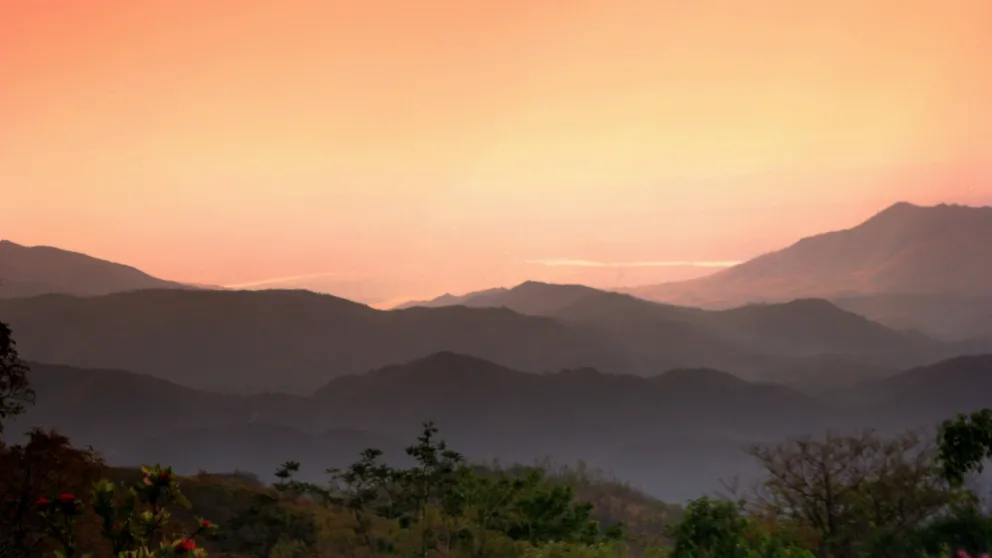 sunset over rolling hills