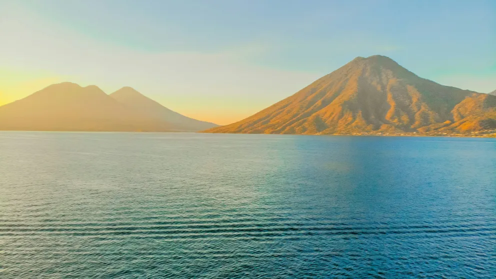 a body of water with mountains in the distance