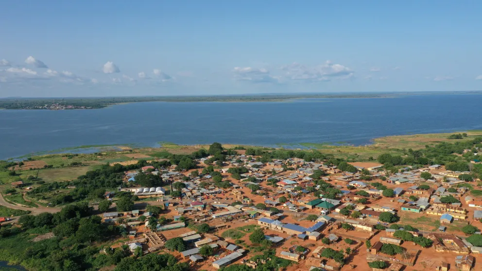 a stretch of land filled with small houses near the coast