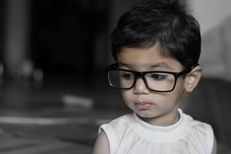 A young boy wearing glasses