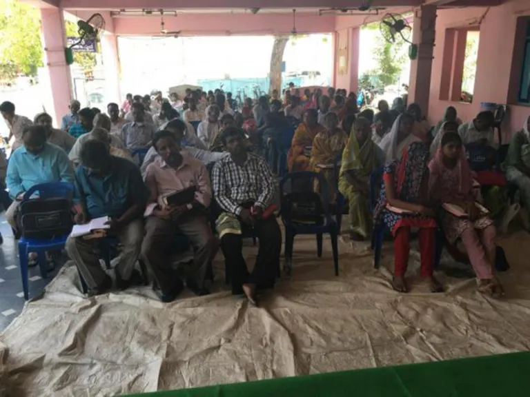 People in India listening to a Bible seminar