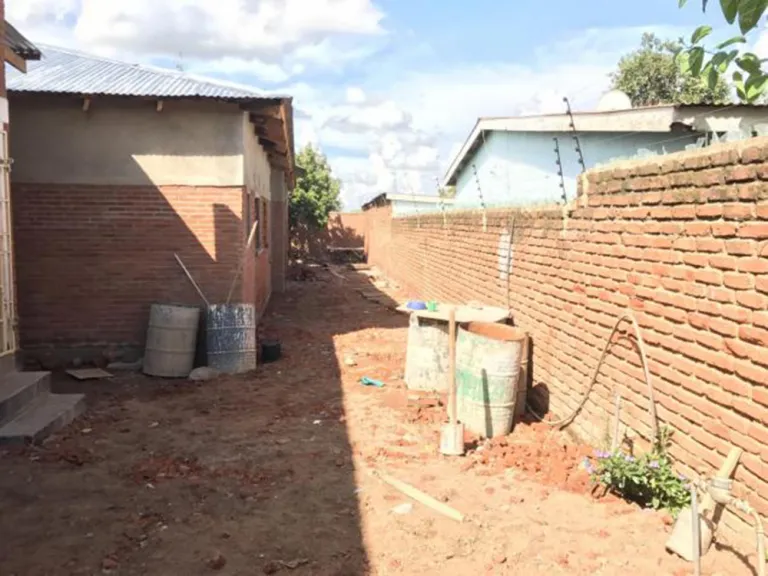 Undeveloped area between a building and a wall