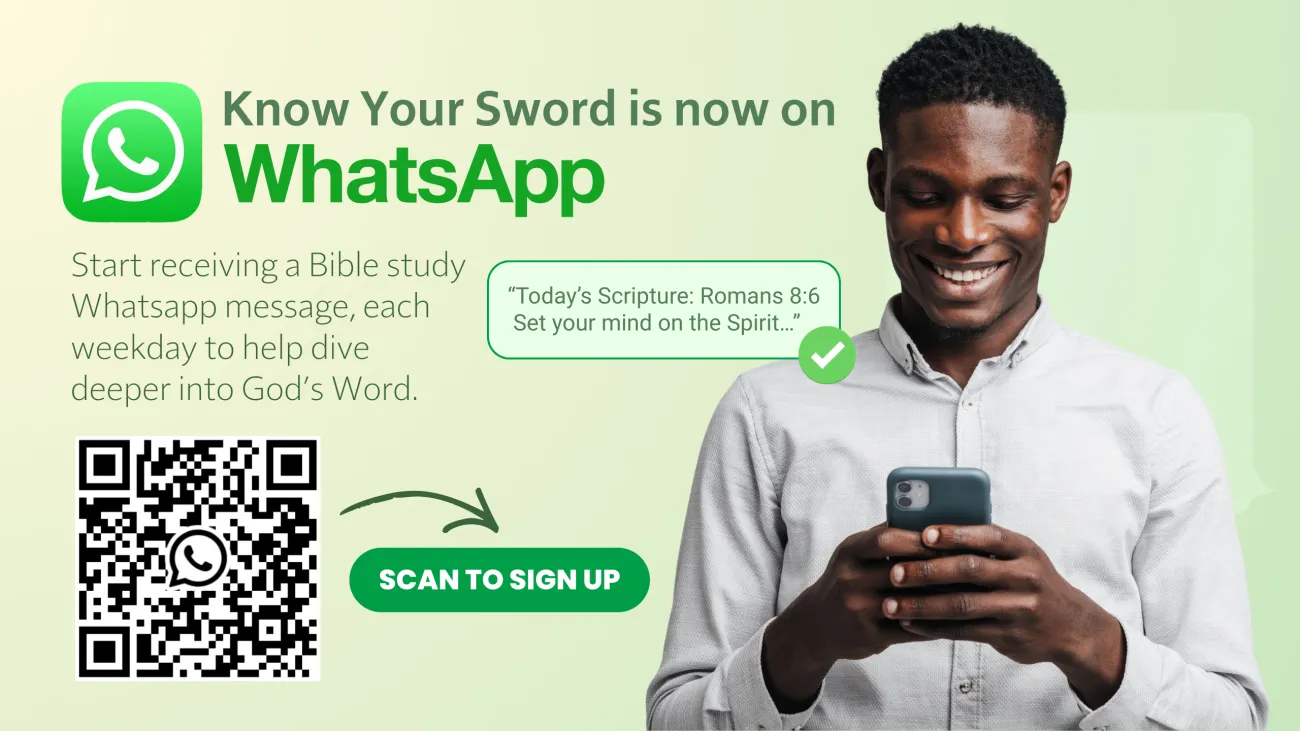 a man smiling as he looks at his phone