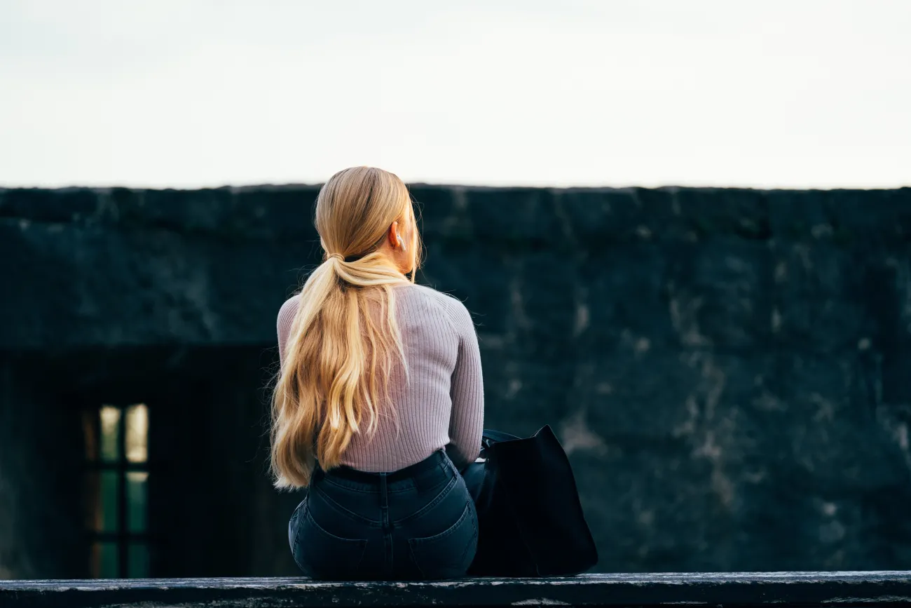 A woman sitting thinking.