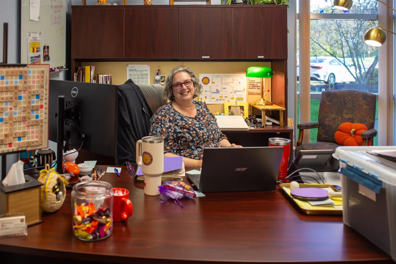 Katherine Rowland sitting behind her desk smiling