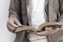 A person reading a Bible.