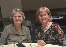 two women seated at a table
