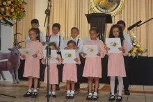 children singing on a stage