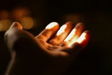Hand extended in the sunlight