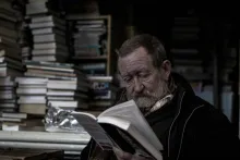 an old man reading a book