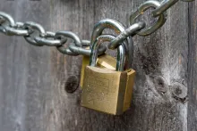 Locks on a chain in front of wooden door